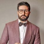 Abhishek Bachchan speaking about criticism and public perception alongside Saurabh Shukla
