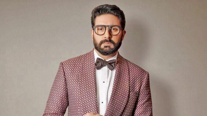 Abhishek Bachchan speaking about criticism and public perception alongside Saurabh Shukla