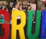 Colourful GRUB letters at The Grub Fest, surrounded by festival attendees in New Delhi.